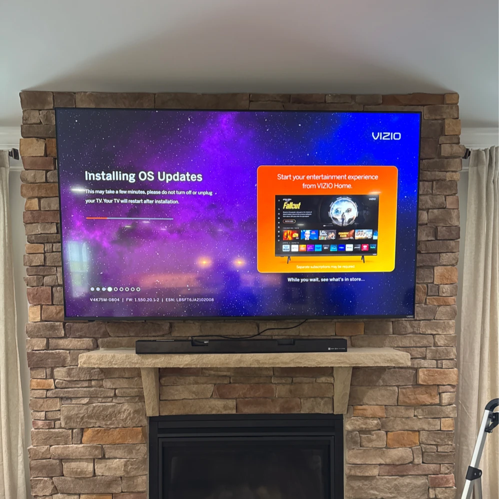 TV mounted above a fireplace with a clean finished installation