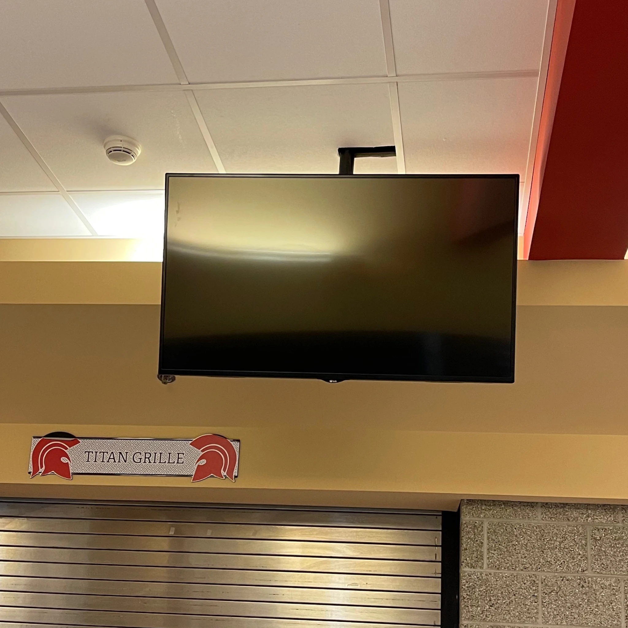 Ceiling TV mounting installation in a school or restaurant setting