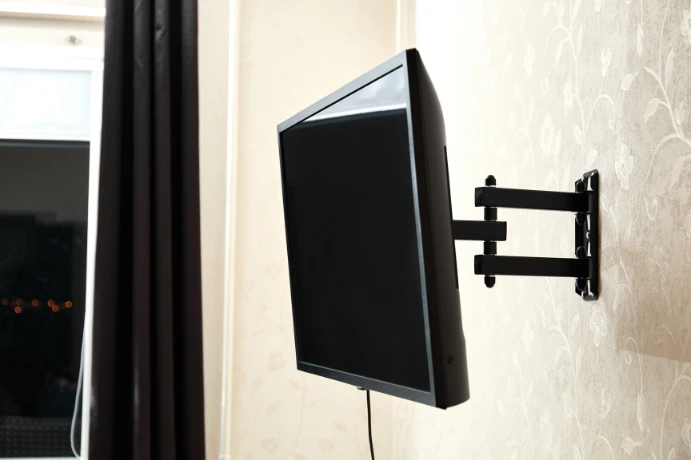Full-motion TV wall mount extended from wall with rear clearance