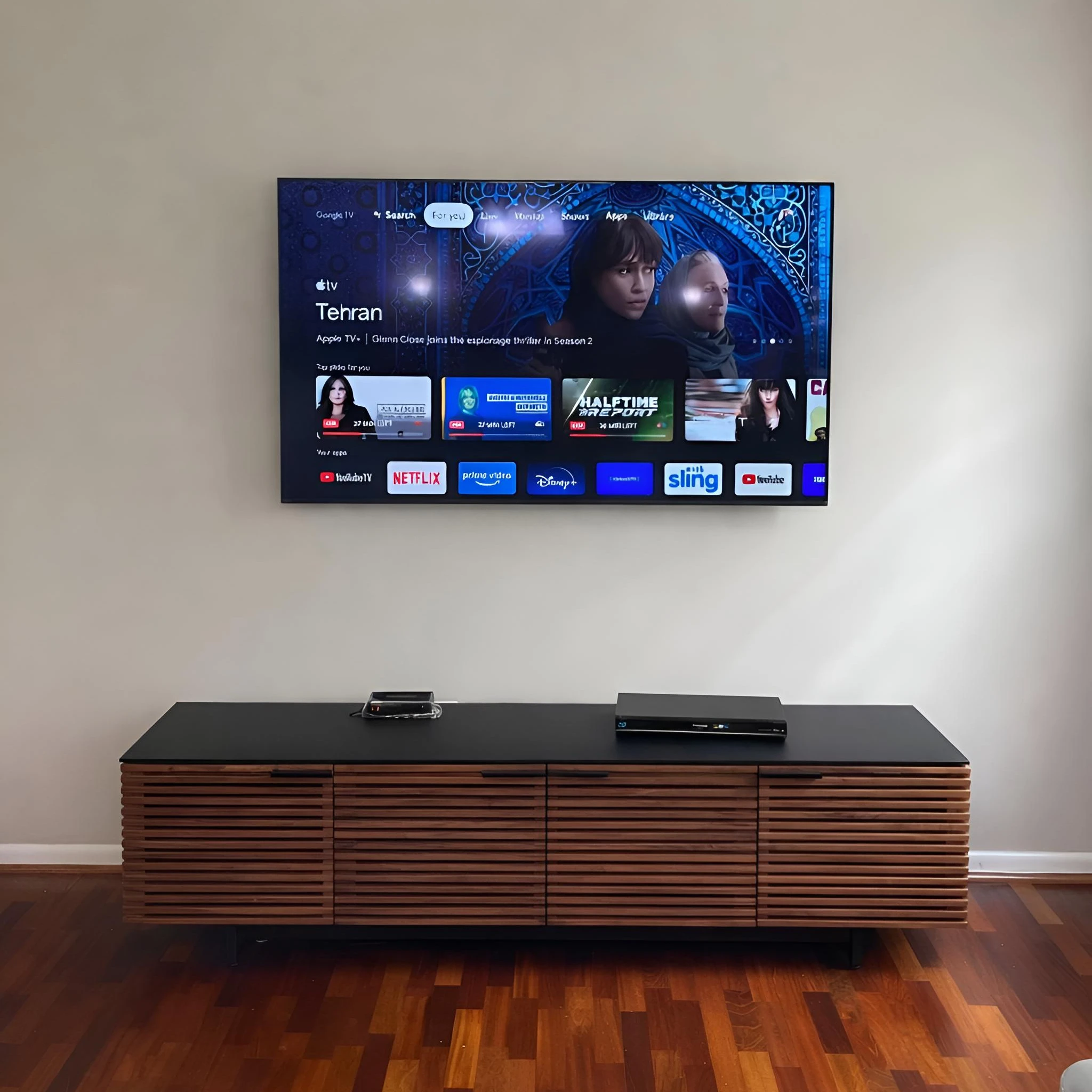 Modern living room home theater installation with a clean wall mounted TV
