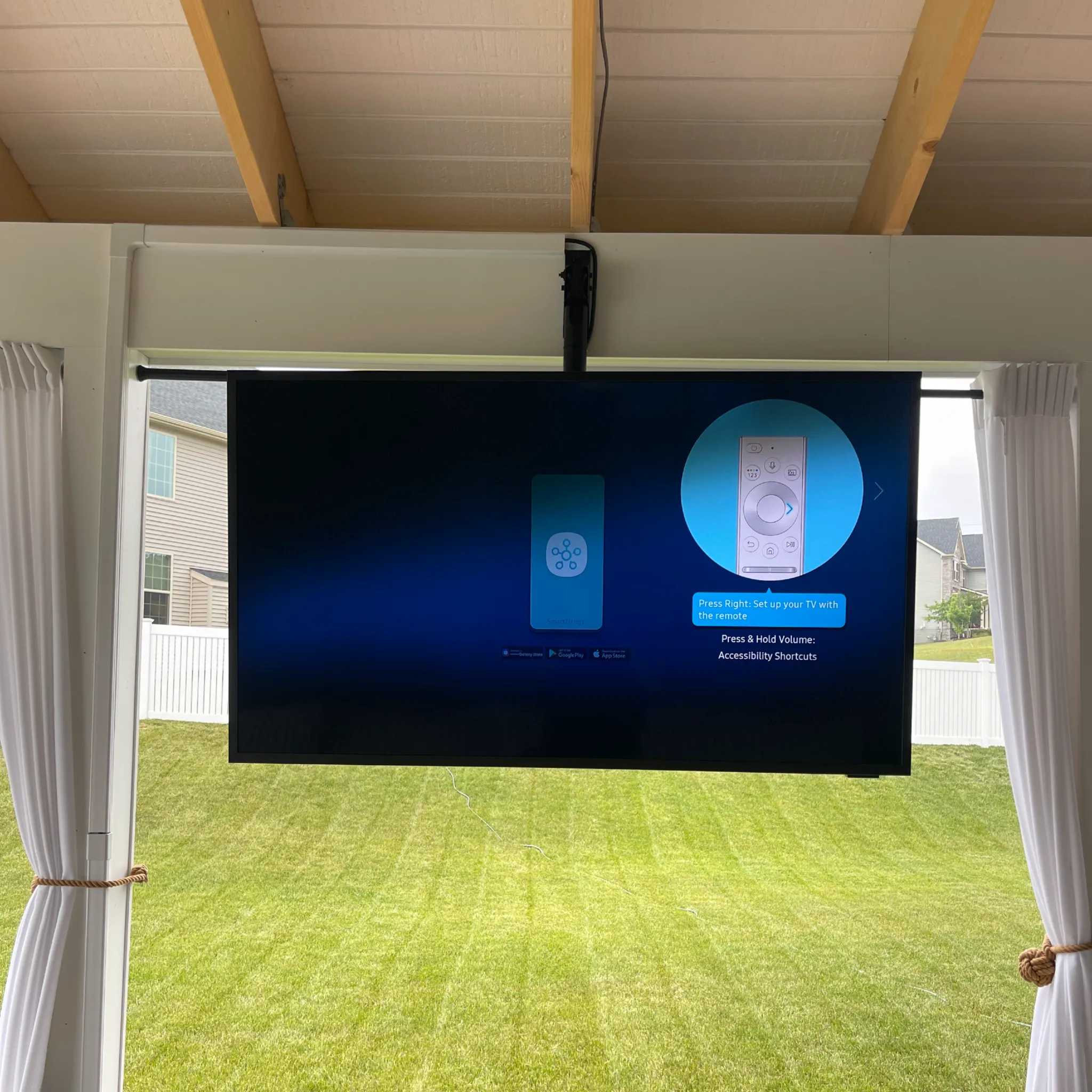 Patio ceiling TV mount installation with a suspended outdoor television