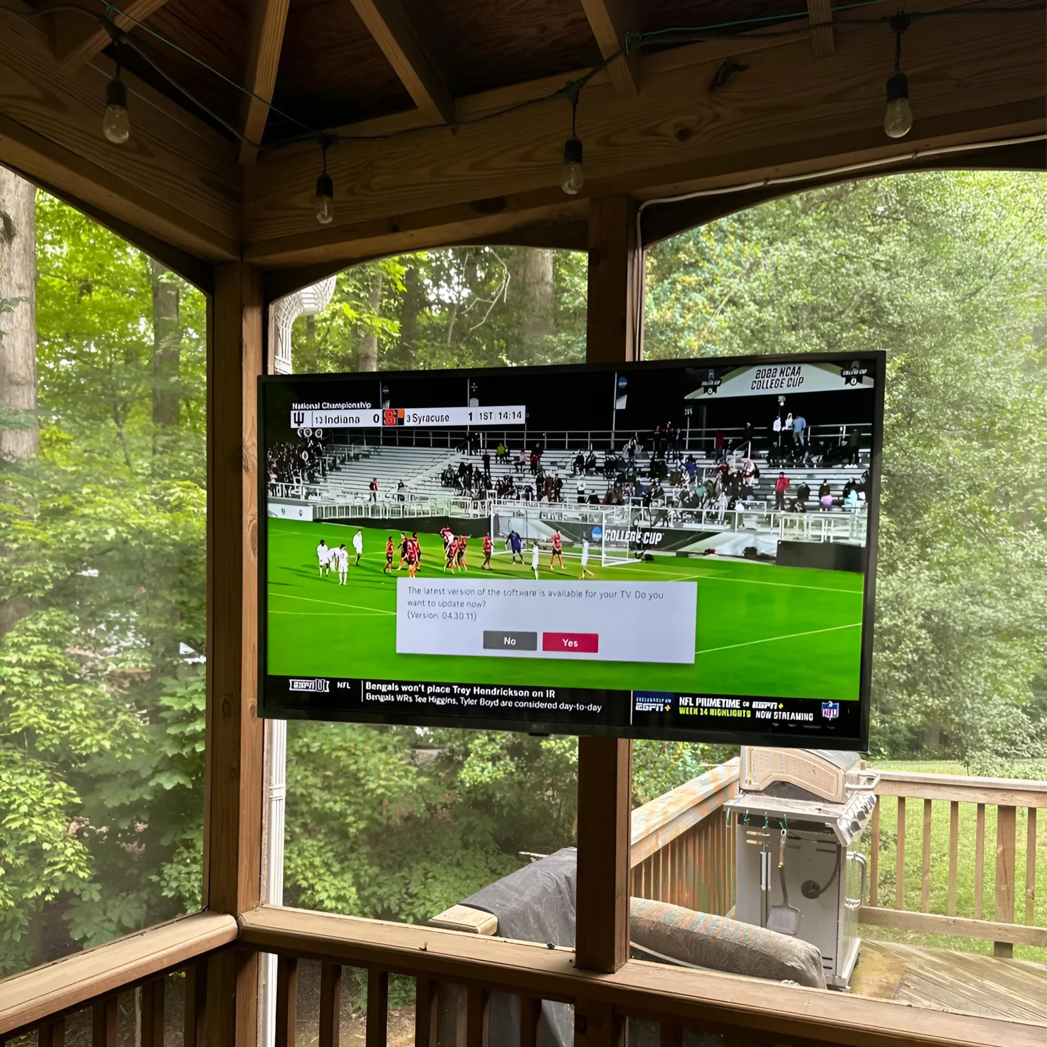 Screened porch ceiling TV mount installation with an outdoor viewing setup