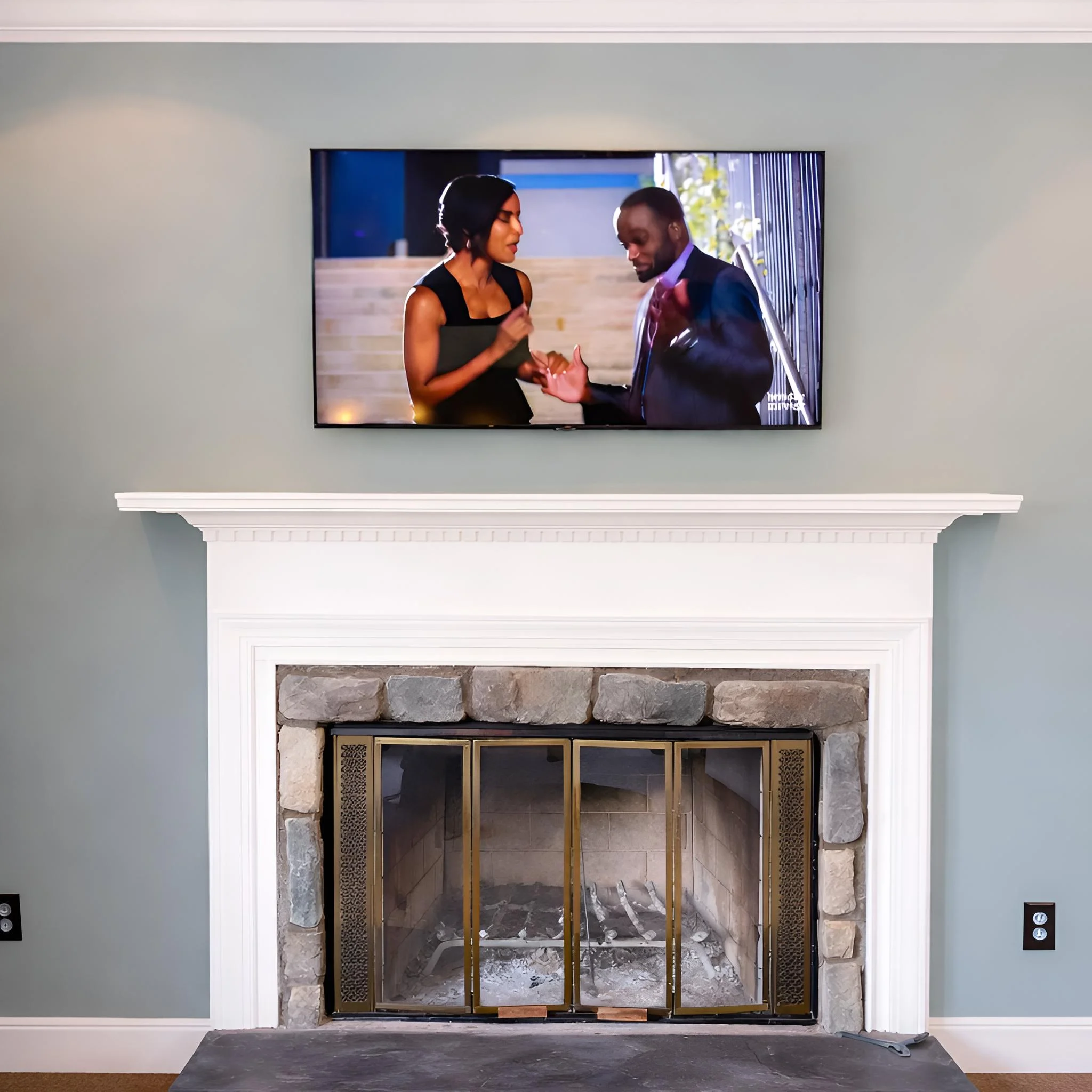 Clean TV mounting above a fireplace with centered placement in Woodbridge VA