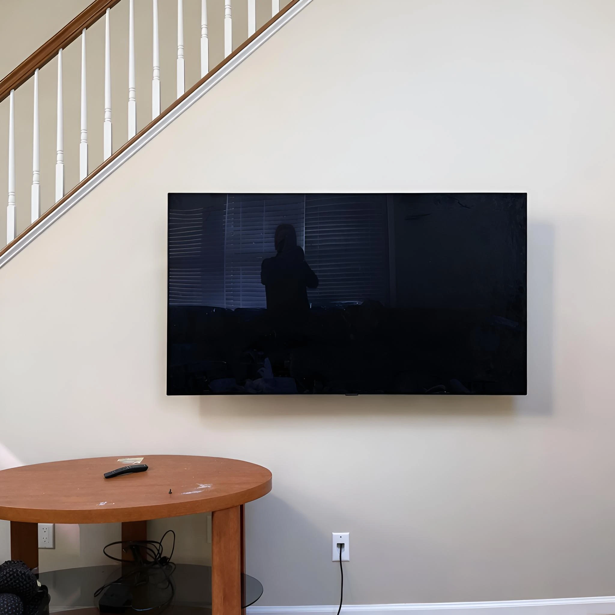 TV wall mount installation in a compact under-stairs area