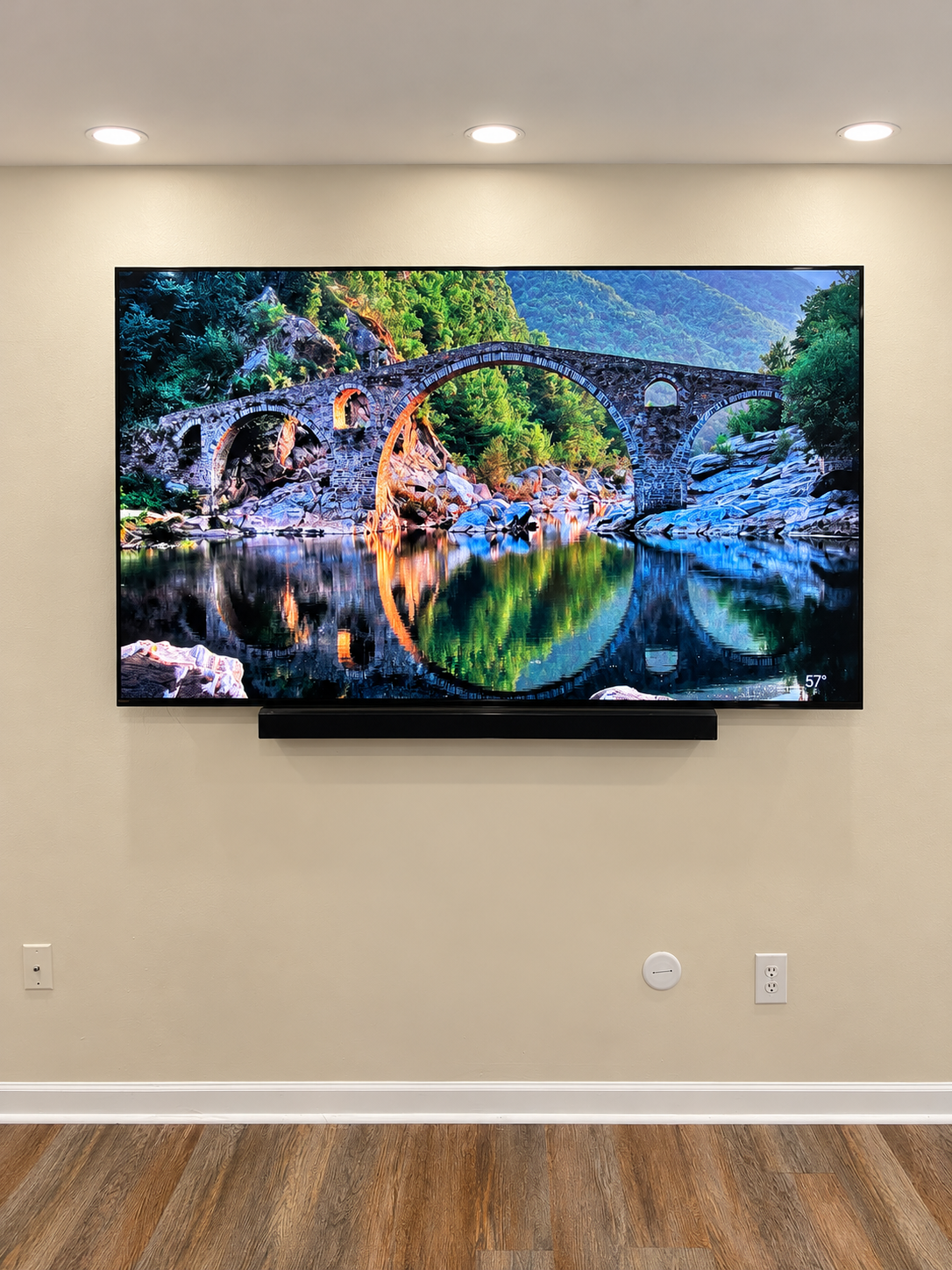 Completed 75-inch TV on a fixed wall mount with soundbar installation and concealed wiring in Woodbridge Virginia